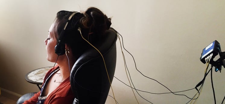 woman sitting in a chair during a neuroptimal neurofeedback session