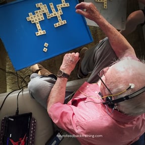 senior during brain training session at home with the neuroptimal system