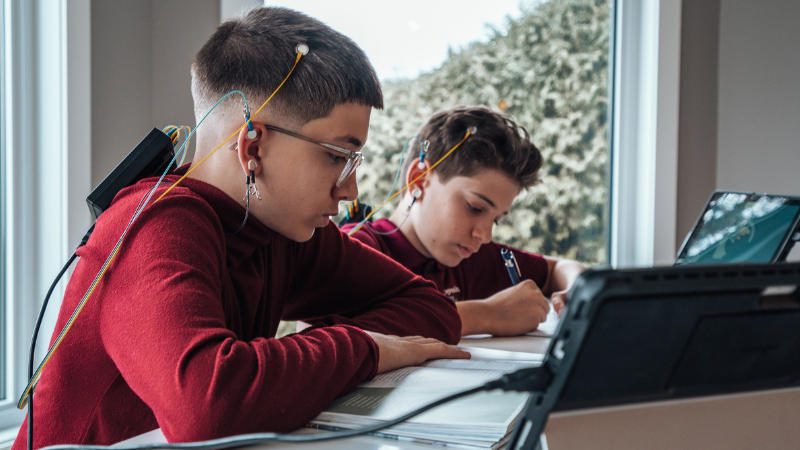 children concentrating on homework while brain training with the neuroptimal home system