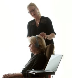 Los Angeles based Certified NeurOptimal® Neurofeedback Trainer Sara St. John applies the EEG sensors on a client.